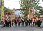 Kolaborasi Polda Sulteng dan FPK, 250 Bendera Merah Putih Dibagikan di Jalan Raya Palu